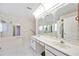 Elegant bathroom featuring dual sinks, large mirrors, a soaking tub, and a walk-in shower at 6405 99Th E St, Bradenton, FL 34202