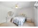 Bedroom with floral comforter, nightstand, dresser and ceiling fan at 6405 99Th E St, Bradenton, FL 34202