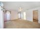 Bright bedroom featuring neutral carpet, a ceiling fan, and access to the walk-in closet and ensuite bathroom at 6405 99Th E St, Bradenton, FL 34202