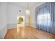 Elegant dining room featuring hardwood floors, decorative wainscoting, and a modern chandelier at 6405 99Th E St, Bradenton, FL 34202