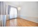 Bright dining room featuring hardwood floors, decorative wainscotting, and a modern chandelier at 6405 99Th E St, Bradenton, FL 34202