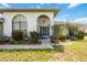 Charming front entrance with stone accents, arched doorway, and beautifully landscaped garden at 6405 99Th E St, Bradenton, FL 34202