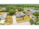 Aerial view highlights the property's manicured lawn, mature trees, and proximity to the lake at 6405 99Th E St, Bradenton, FL 34202