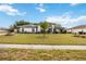 Charming one-story home with a well-manicured lawn and lush landscaping under a sunny blue sky at 6405 99Th E St, Bradenton, FL 34202