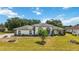 Charming home featuring manicured lawn, elegant architectural details, and lush landscaping at 6405 99Th E St, Bradenton, FL 34202