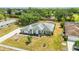 Aerial view showcases a beautifully landscaped home with lush green lawn and circular flower beds at 6405 99Th E St, Bradenton, FL 34202