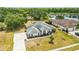 An aerial shot reveals a well-maintained home with a landscaped front yard and a glimpse of the serene lake nearby at 6405 99Th E St, Bradenton, FL 34202