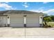 Spacious two-car garage with gray doors, stone accents, and updated lighting fixtures at 6405 99Th E St, Bradenton, FL 34202