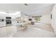 Open-concept kitchen showcasing white cabinets, tiled floors, and seamless transition to the living room at 6405 99Th E St, Bradenton, FL 34202