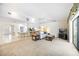 A bright and airy living room with vaulted ceilings, carpeted floors and view to the kitchen at 6405 99Th E St, Bradenton, FL 34202