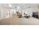 Open-concept living room showcasing vaulted ceilings, neutral carpet, and connectivity with the breakfast area at 6405 99Th E St, Bradenton, FL 34202