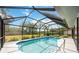 Backyard pool features a screened enclosure and lush landscaping for privacy at 6405 99Th E St, Bradenton, FL 34202