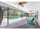 Screened-in pool with tropical ceiling fans and outdoor seating at 6405 99Th E St, Bradenton, FL 34202