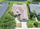 Aerial view of a well-maintained home with a spacious backyard and community pond at 6415 67Th E St, Bradenton, FL 34203