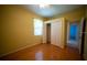 Bedroom featuring hardwood floors, yellow walls, and a closet with bi-fold doors at 6415 67Th E St, Bradenton, FL 34203