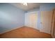 Spare bedroom with hardwood floors, light blue walls and a closet with bi-fold doors at 6415 67Th E St, Bradenton, FL 34203