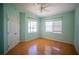 Bright bedroom with hardwood floors, two windows, and a closet with bi-fold doors at 6415 67Th E St, Bradenton, FL 34203