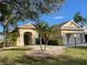 Charming single-story home featuring a well-manicured lawn, palm trees, and a welcoming entrance at 6415 67Th E St, Bradenton, FL 34203