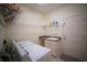 Bright laundry room featuring a washing machine, dryer, sink, and overhead storage at 6415 67Th E St, Bradenton, FL 34203