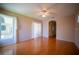 Open living room with hardwood floors, a large window, and access to the back patio at 6415 67Th E St, Bradenton, FL 34203