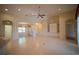 Spacious living room with tile flooring, ceiling fan, and archways to other rooms at 6415 67Th E St, Bradenton, FL 34203