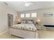 Comfortable bedroom with a king-sized bed, nautical decor, and natural light from three large windows at 6546 Blue Grosbeak Cir, Lakewood Ranch, FL 34202