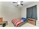 Bedroom with a ceiling fan, a window with black curtains, and a bed with an American flag patterned blanket at 6546 Blue Grosbeak Cir, Lakewood Ranch, FL 34202