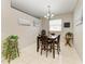 Cozy dining area with a modern chandelier, seating four, and well-decorated walls at 6546 Blue Grosbeak Cir, Lakewood Ranch, FL 34202