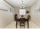 Inviting dining room with a wooden table set, chandelier lighting, and charming wall art at 6546 Blue Grosbeak Cir, Lakewood Ranch, FL 34202