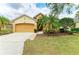 Well-manicured lawn of a single-story house, with an attached 2-car garage and brick-lined walkway at 6546 Blue Grosbeak Cir, Lakewood Ranch, FL 34202