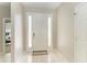 Bright foyer with tile flooring, a white front door and sidelights for ample natural light at 6546 Blue Grosbeak Cir, Lakewood Ranch, FL 34202