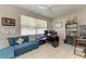 Home office featuring a large window, tile flooring, and a comfortable blue couch with lots of natural light at 6546 Blue Grosbeak Cir, Lakewood Ranch, FL 34202
