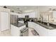 Well-lit kitchen boasts granite counters, stainless steel appliances, and an efficient island at 6546 Blue Grosbeak Cir, Lakewood Ranch, FL 34202