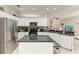 Bright kitchen with white cabinetry, stainless steel appliances, and central island at 6546 Blue Grosbeak Cir, Lakewood Ranch, FL 34202