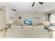 Bright living room with comfortable furniture, a ceiling fan, and access to outdoor space at 6546 Blue Grosbeak Cir, Lakewood Ranch, FL 34202