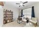 Bright office with a ceiling fan, a wooden desk, and a charming display shelf with elegant décor at 6546 Blue Grosbeak Cir, Lakewood Ranch, FL 34202