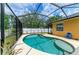 Backyard pool area featuring a kidney-shaped pool and hot tub surrounded by ample patio space and privacy fence at 6546 Blue Grosbeak Cir, Lakewood Ranch, FL 34202