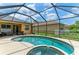 Inviting screened-in pool and spa with a sunny deck and comfortable seating area at 6546 Blue Grosbeak Cir, Lakewood Ranch, FL 34202