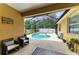 Screened-in outdoor pool area featuring a private pool and hot tub, outdoor seating and decorative plantings at 6546 Blue Grosbeak Cir, Lakewood Ranch, FL 34202