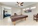 Recreation area featuring a pool table, ceiling fan, and a cozy seating area at 6546 Blue Grosbeak Cir, Lakewood Ranch, FL 34202