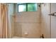 Spacious tile shower features rainfall showerhead, frosted window and recessed storage shelves at 6931 Brier Creek Ct, Lakewood Ranch, FL 34202