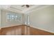 Bright bedroom with hardwood flooring, tray ceiling, and access to lanai at 6931 Brier Creek Ct, Lakewood Ranch, FL 34202