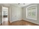 Beautiful bedroom with hardwood floors, closet, and an arched window at 6931 Brier Creek Ct, Lakewood Ranch, FL 34202