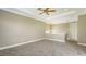Spacious bedroom with neutral carpet, tray ceiling, fan and ample natural light at 6931 Brier Creek Ct, Lakewood Ranch, FL 34202