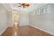 Bedroom featuring hardwood flooring, tray ceiling, and a ceiling fan at 6931 Brier Creek Ct, Lakewood Ranch, FL 34202