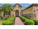 Stunning home exterior featuring a brick walkway, manicured bushes and a beautiful front entrance with double doors at 6931 Brier Creek Ct, Lakewood Ranch, FL 34202