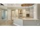 Bright kitchen featuring white cabinets, stainless steel appliances, a large island, and a stylish range hood at 6931 Brier Creek Ct, Lakewood Ranch, FL 34202