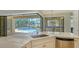 Bright kitchen with stainless steel appliances and white countertops overlooking screened in pool and lanai at 6931 Brier Creek Ct, Lakewood Ranch, FL 34202
