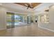 Spacious living room with tile flooring, a wood-paneled ceiling, and sliding glass doors to a screened-in pool area at 6931 Brier Creek Ct, Lakewood Ranch, FL 34202