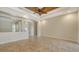 Spacious living room featuring a decorative ceiling fan and travertine tile floors at 6931 Brier Creek Ct, Lakewood Ranch, FL 34202